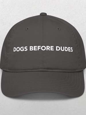 Show your canine pride with the Classic Organic Dad Cap in Charcoal, featuring DOGS BEFORE DUDES boldly on the front—a perfect hat for any dog lover.