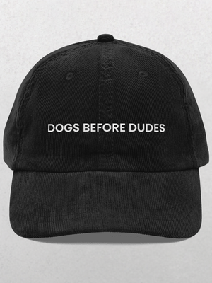 The Chord Vintage Cap - Dogs Before Dudes is a trendy black baseball hat with white DOGS BEFORE DUDES embroidery on the front, perfect for dog lovers.