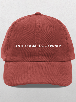 The Chord Vintage Cap - Anti Social Dog Owner features ANTI-SOCIAL DOG OWNER embroidered in white on the front, shown in burgundy corduroy against a light gray background—a fun gift for dog dads or anyone with humor.