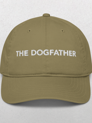 The Classic Organic Dad Cap - The Dog Father is a khaki hat with “THE DOGFATHER” boldly embroidered in white, making this fun pet accessory stand out against a plain background.