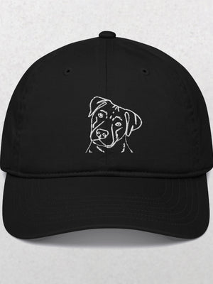Embroidered Line art Pet Portrait Organic Classic Dad Cap in black features a simple white line dog head design on the front—an ideal unique pet keepsake, shown against a plain light background.