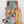 A hand holds an iPhone with the Custom Pet iPhone Case – Abstract Art, featuring a vibrant painted dog inspired by the real pet in an inset photo. The design pops with bold blue, yellow, red, and black brush strokes.