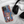 A Custom Pet iPhone Case - Oil Painting with a brown puppy design rests next to black over-ear headphones on a soft white fabric surface.